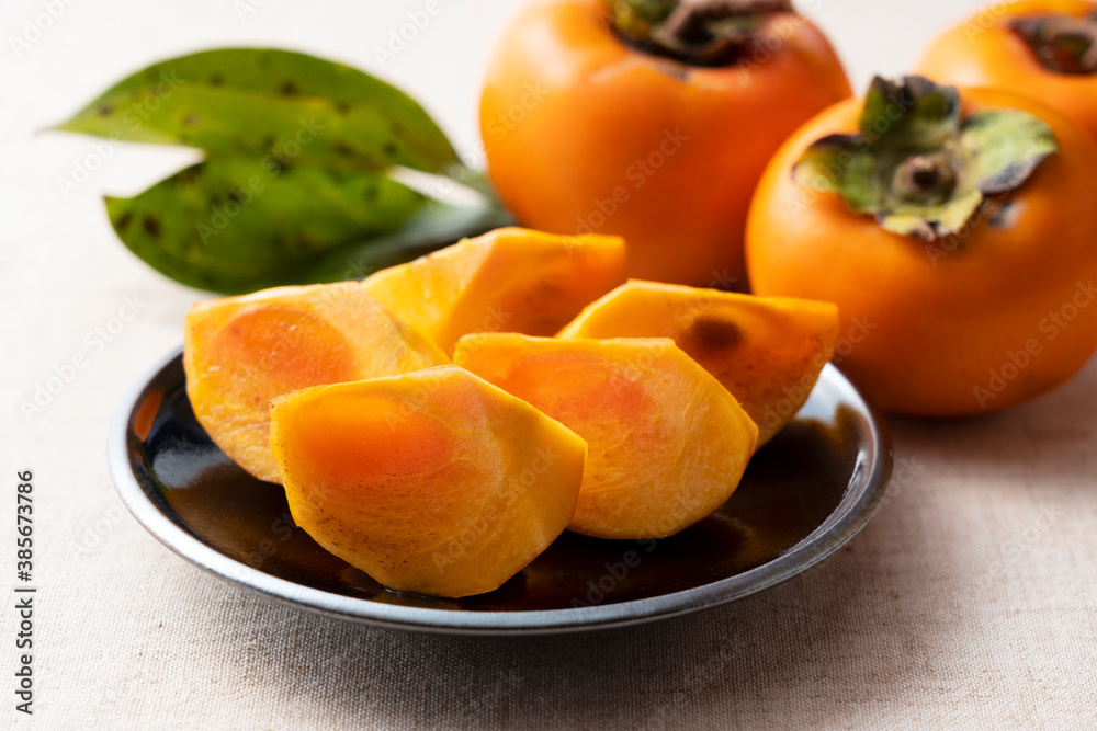 Cut Japanese persimmons on a plate