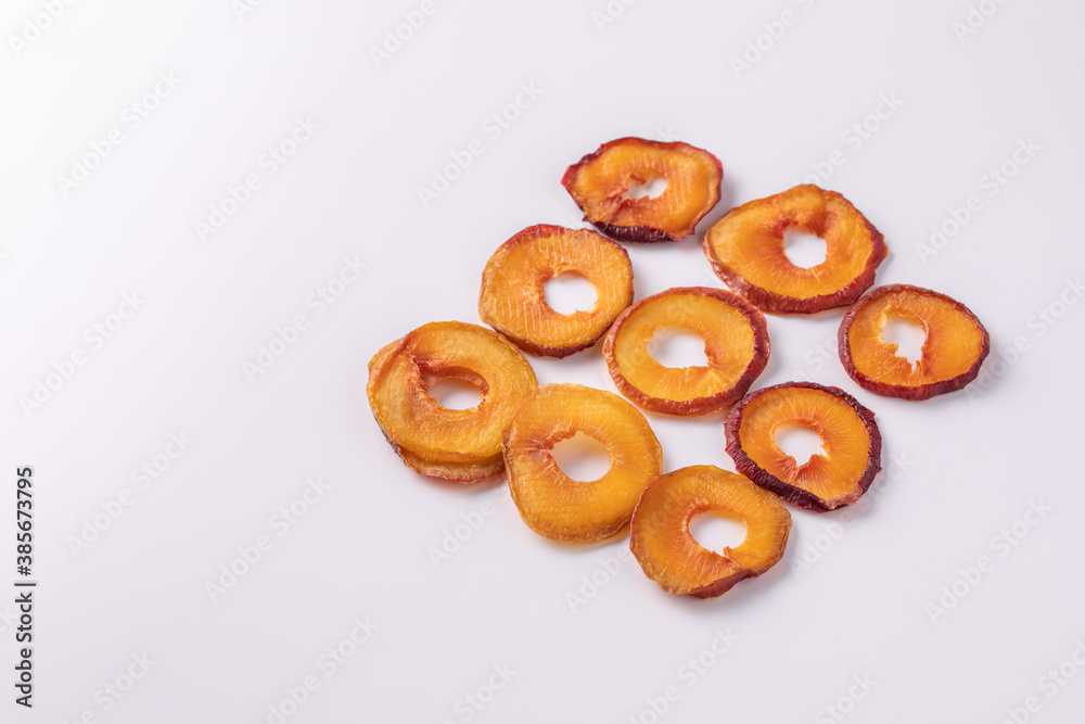 slices of dried plum on a white background. dried fruits. eco.top view. slices of dried plum on a white background. dried fruits. eco.top view.