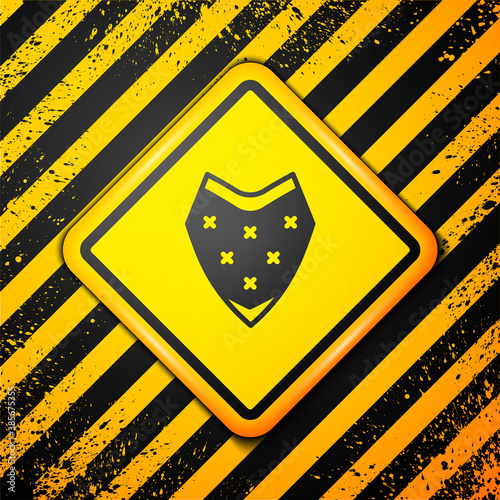Black Traditional mexican poncho clothing icon isolated on yellow background. Warning sign. Vector.