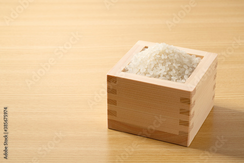 Rice in a Japanese Masu in a wooden background