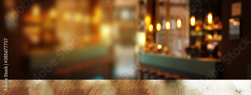 top of wood table with blur light in pub or bar night party banner background
