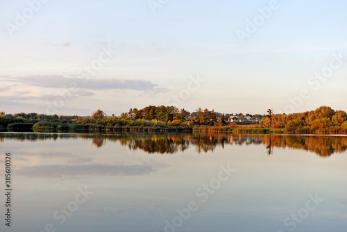 reflection of trees in the lake © karolinaklink