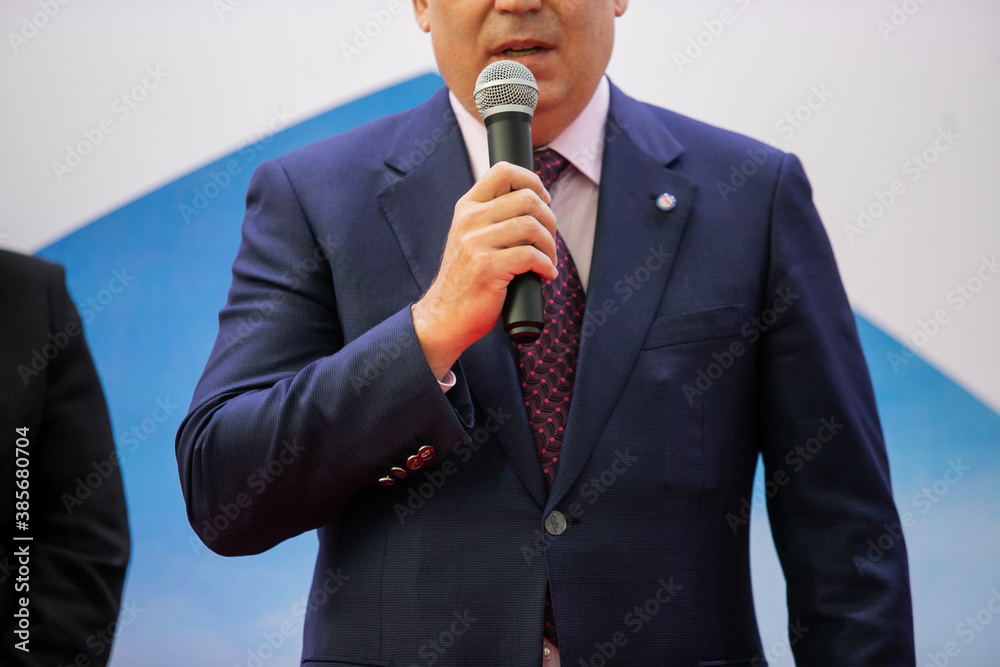 Smart businessman speech speaking present in seminar, talking with microphone keynote in convention or conference hall. Startup Business speaker teaching to audience in university classroom Smart businessman speech speaking present in seminar, talking with microphone keynote in convention or conference hall. Startup Business speaker teaching to audience in university classroom