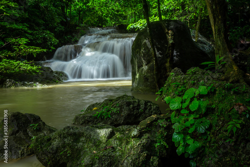 A beautiful waterfall deep in the tropical forest, steep mountain adventure in the rainforest.
