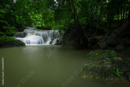 A beautiful waterfall deep in the tropical forest  steep mountain adventure in the rainforest.