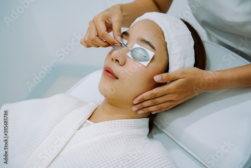 Woman getting spa treatment with protective goggles.