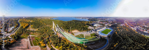 Aerial panoramic view of Lahti sports centre with three ski jump towers.