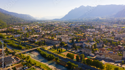 Scenic aerial view of French town of Albertville in green alpine valley on Arly River on sunny summer day photo