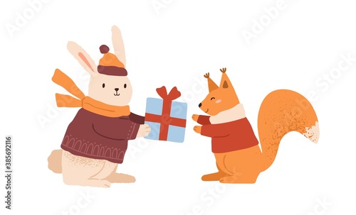 Funny rabbit in warm clothes giving gift box to cute squirrel vector flat cartoon illustration. Happy childish animals celebrating Christmas or Birthday isolated. Amusing characters in winter apparel