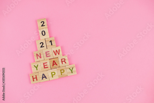 Happy New Year and Merry Christmas. Scrabble letters. Letter tiles spelling celebration holiday.