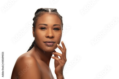 Touch. Portrait of beautiful african-american woman isolated on white studio background. Beauty, fashion, skincare, cosmetics concept. Copyspace for ad. Well-kept skin and natural fresh look.