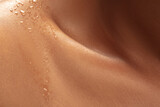 Close up of female neck and shoulder with water drops in beautiful shine. African-american model. Beauty, fashion, skincare, cosmetics concept. Copyspace for ad. Well-kept skin, fresh look.