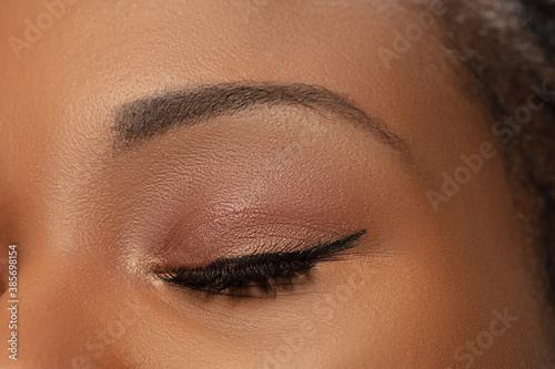 Brows and eyelashes. Close up of female eyes with nude make up. Beautiful african-american model. Beauty, fashion, skincare, cosmetics concept. Copyspace for ad. Well-kept skin, fresh look.