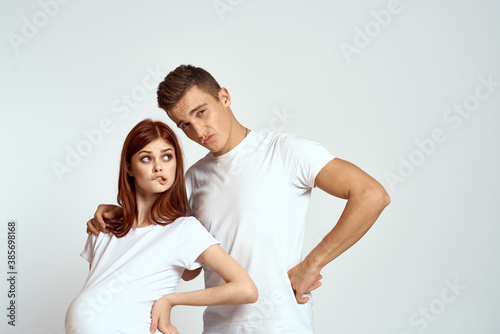 a pregnant woman and a young man are waiting for a baby on a light background emotions family love