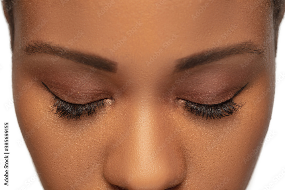 Brows and eyelashes. Close up of female eyes with nude make up. Beautiful african-american model. Beauty, fashion, skincare, cosmetics concept. Copyspace for ad. Well-kept skin, fresh look.