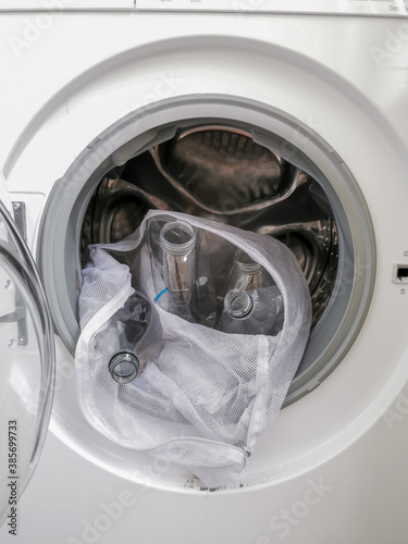 Washing machine filled with plastic bottles representing micro plastic waste pollution during laundry