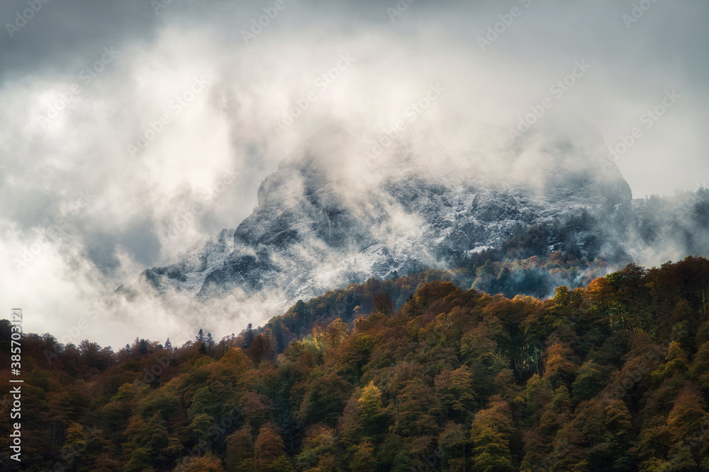 Autumn colors on the cloudy mountains
