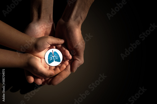 Adult and child hands holding lung, world tuberculosis day, world no tobacco day, lung cancer, coronavirus covid-19, Pulmonary hypertension, Pneumonia, copd, eco air pollution,organ donation concept