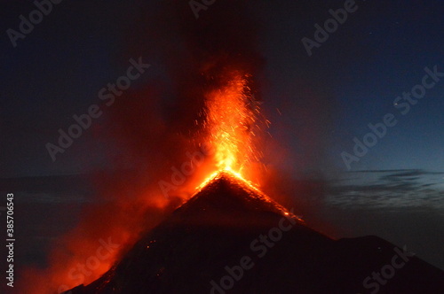 Sunrise hiking and camping on the active Volcan Acatenango with a view to the volcano Fuego eruption - Guatemala