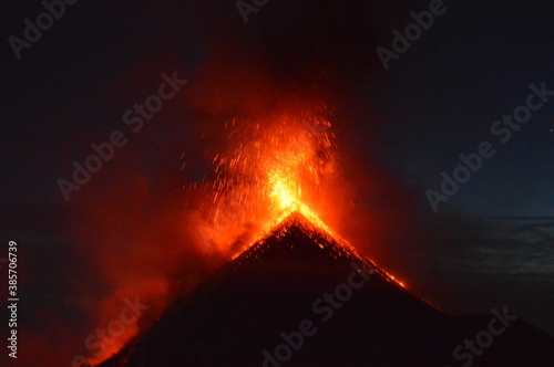 Sunrise hiking and camping on the active Volcan Acatenango with a view to the volcano Fuego eruption - Guatemala