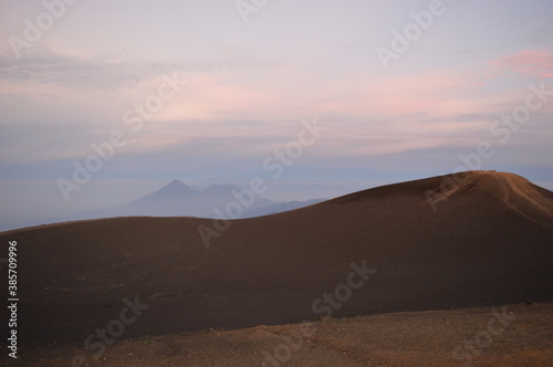 Sunrise hiking and camping on the top of the active Volcan Acatenango while the Volcano Fuego is erupting - Guatemala