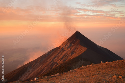 Sunrise hiking and camping on the top of the active Volcan Acatenango while the Volcano Fuego is erupting - Guatemala