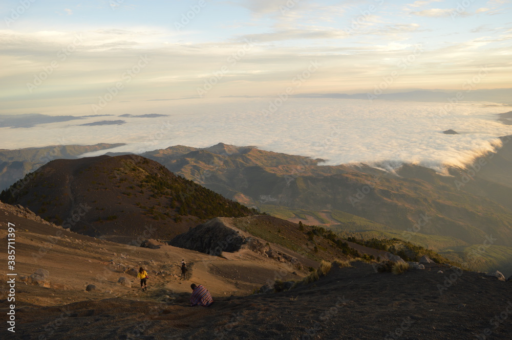 Sunrise hiking and camping on the top of the active Volcan Acatenango while the Volcano Fuego is erupting - Guatemala