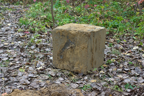 concrete cube with rebar, dug out of the ground