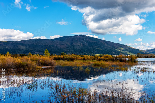 landscape with Cerknica lake and Alps mountains in autumn