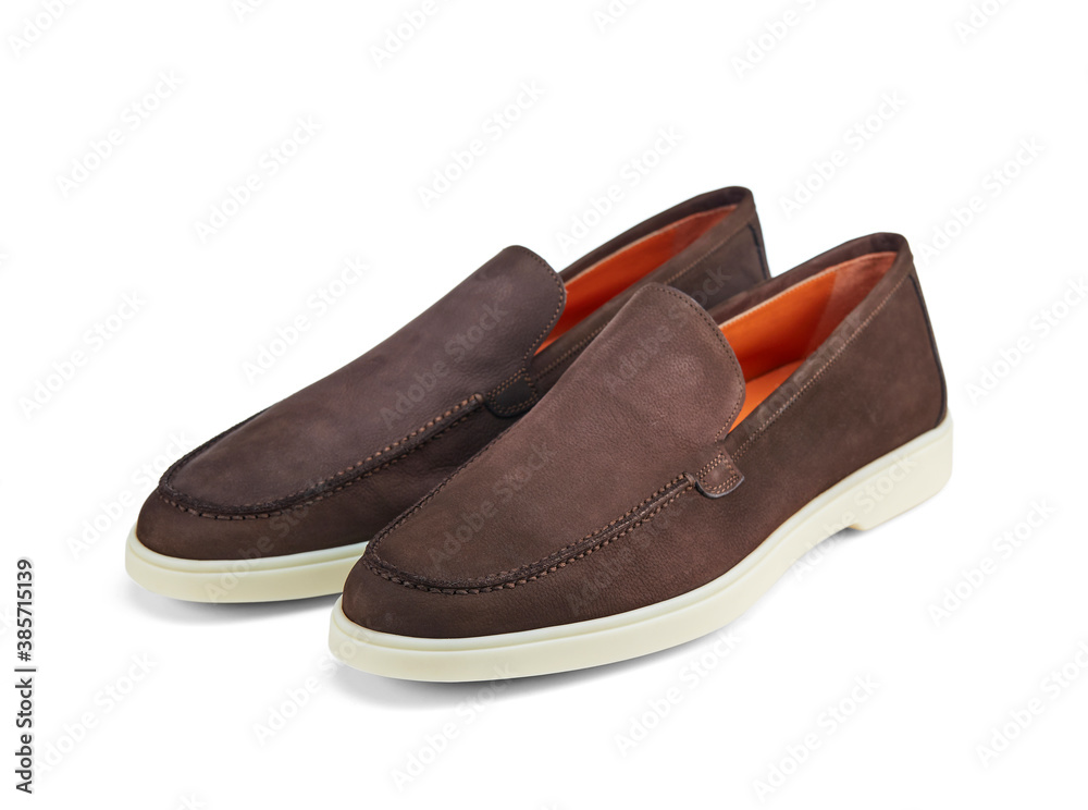 Pair of light men's summer shoes made of brown suede on a white rubber sole. Light and practical shoes for everyday wear. Pair of light men's summer shoes made of brown suede on a white rubber sole. Light and practical shoes for everyday wear.