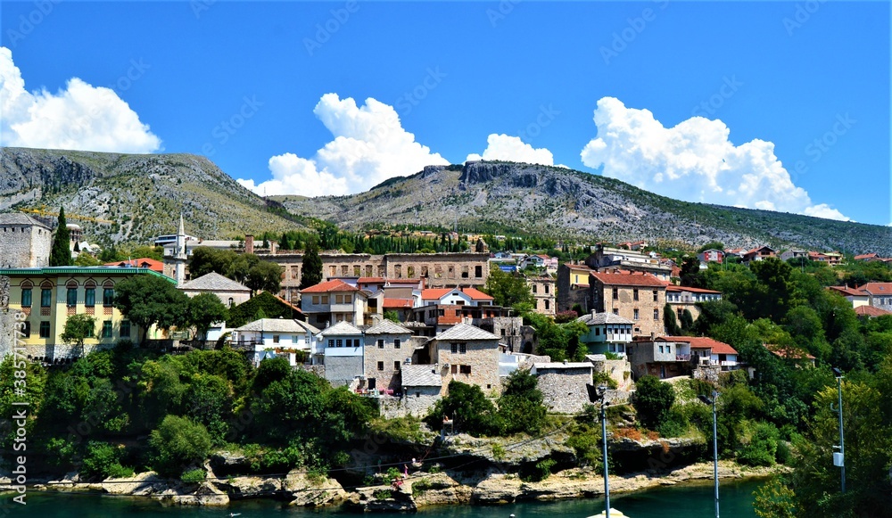 City of Mostar Bosnia and Hercegovina.Ancient and Ottoman City of Mostar and great Mostar Bridge. Neretva River and Vintage Buildings during sunny day and blue sky.