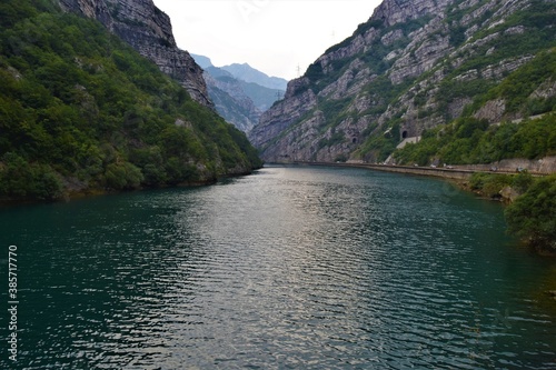 Green River Neretva flows between huge mountains during overcast weather. Bosnia and herzegovina. photo