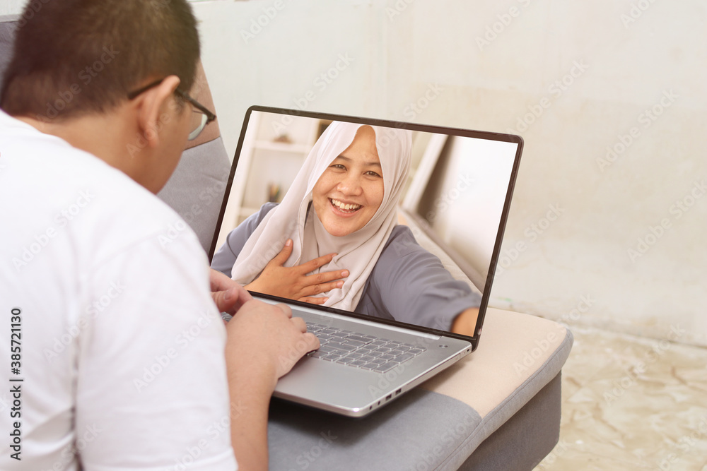 Man doing video call with his woman on laptop during stay at home, coronavirus pandemic, distance internet communication Man doing video call with his woman on laptop during stay at home, coronavirus pandemic, distance internet communication