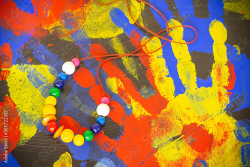 A colorful necklace on a vivid painted background.