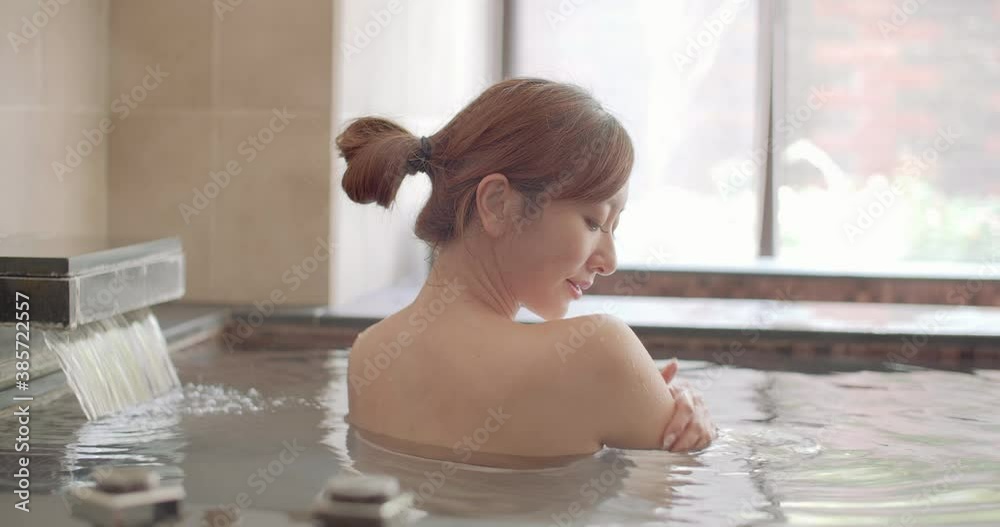 Asian Young woman relaxing and massaging in hot spring
Asian Young woman relaxing and massaging in hot spring