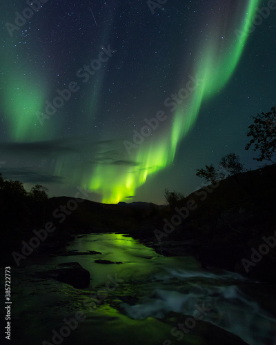 Beautiful night sky with Aurora Borealis aka northern lights in the fjords in Norway. © finnghal