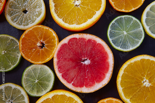 citrus fruit slices on dark surface