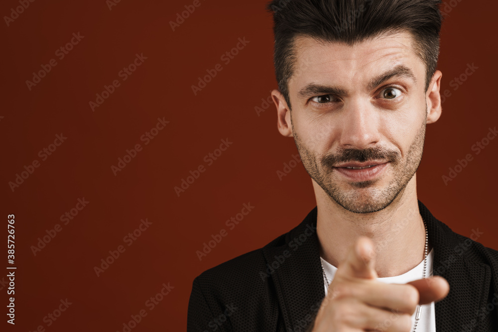 Photo of young handsome man pointing finger at camera