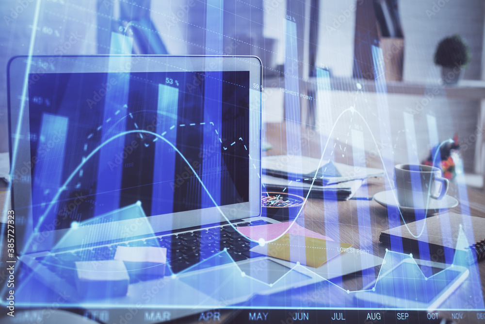 Stock market graph and table with computer background. Multi exposure. Concept of financial analysis.