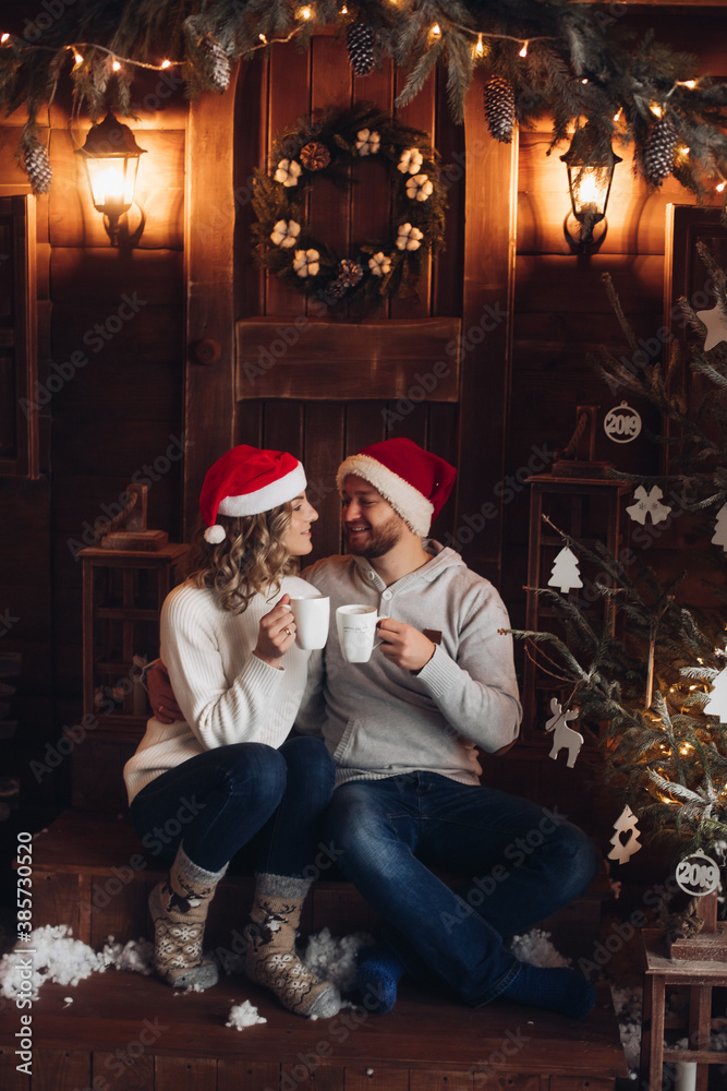 Pretty blonde woman love her handsome husband and spends a lot of time with him in Christmas night