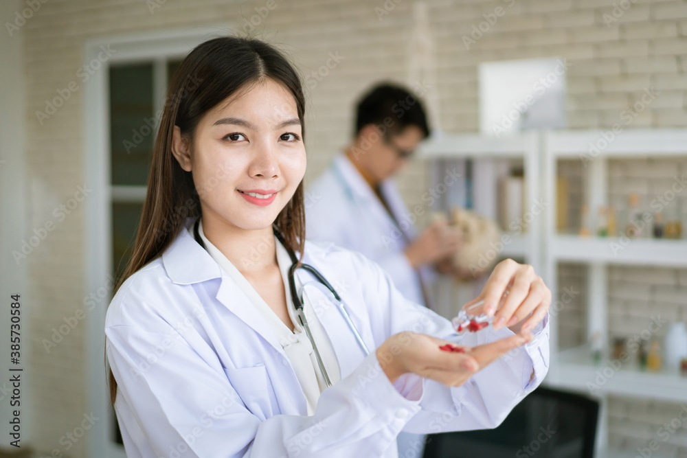 Doctor showing a red pills on hands, nutrition supplements. Doctor showing a red pills on hands, nutrition supplements.