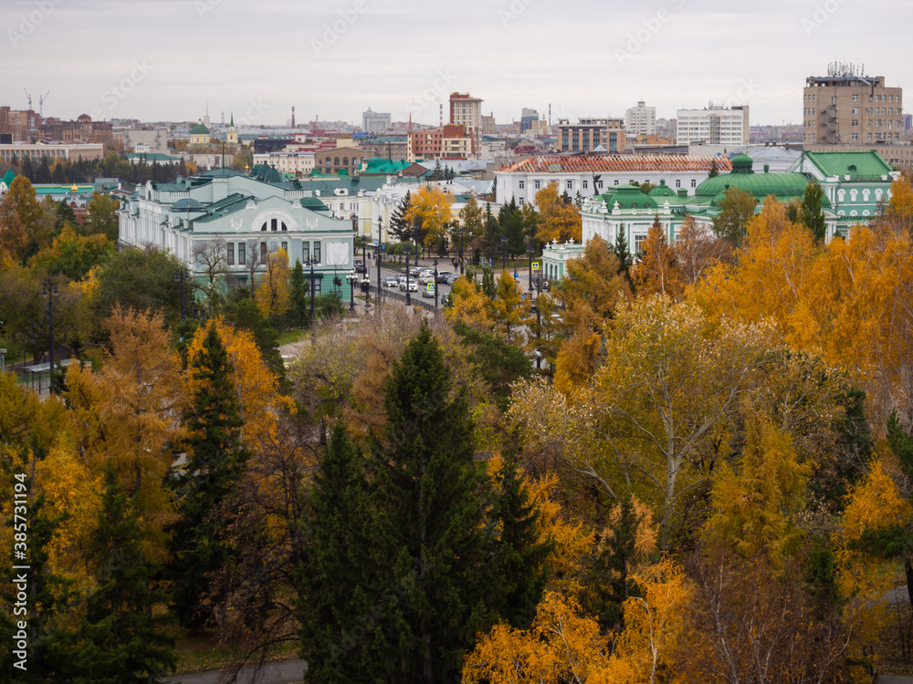 Victory Square, Dzerzhinsky Square, Museum of Fine Arts and Drama Theater in Omsk in autumn from above. Yellow trees