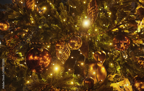 Christmas tree, decorated with light garland and toys