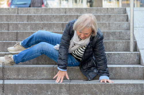 фотографія Senior woman falling down stone steps outdoors