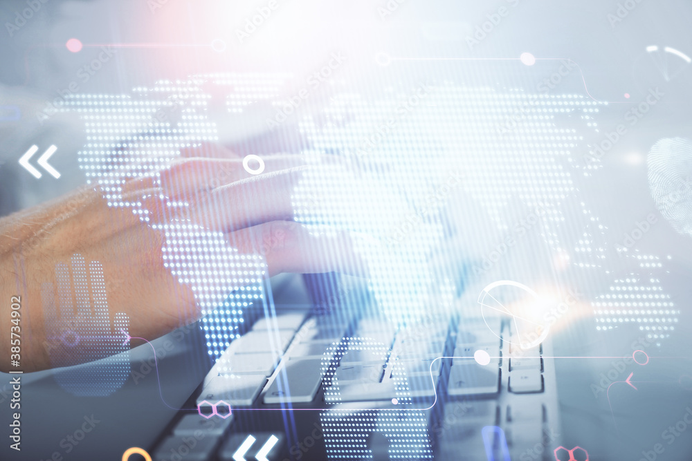 Double exposure of world map hologram with man working on computer on background. Concept of worldwideweb.