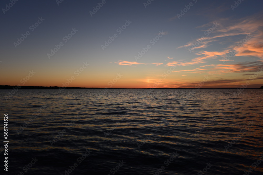 Twilight blue sky over lake water with wave patterns