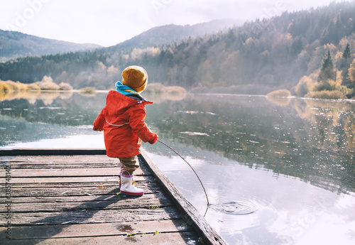 Little child spend time outside in nature.