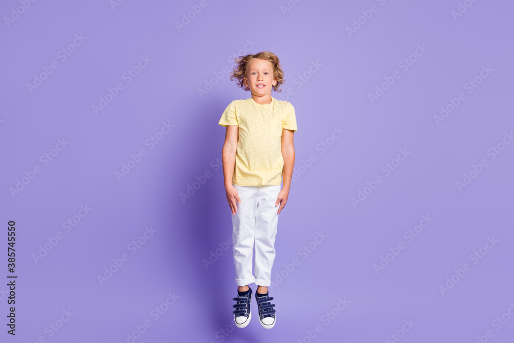 Full size photo of charming boy jump up wear casual style clothes sneakers isolated over pastel purple color background Full size photo of charming boy jump up wear casual style clothes sneakers isolated over pastel purple color background