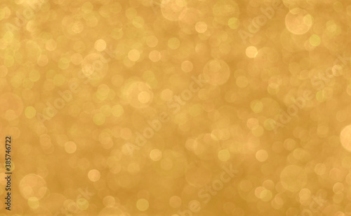 Gold light shiny bokeh abstract blur background with bright round defocus golden pattern, can use for Christmas festive decoration and any design