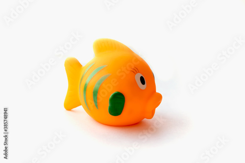Orange rubber fish toy isolated on white background.